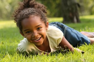 A young child laying in the grass