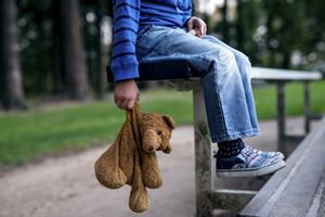 A child holding a teddy bear