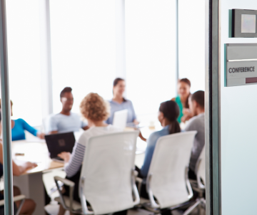 a conference room with people meeting inside