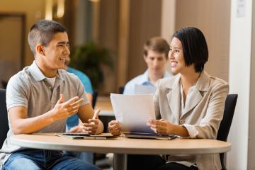 Two people sitting at a table talking