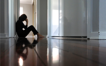 person sitting in a hallway